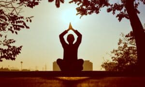 person meditating outside