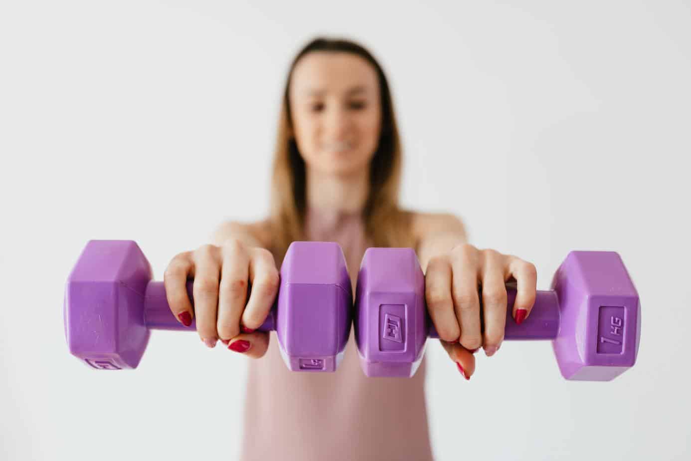 woman holding dumbbells